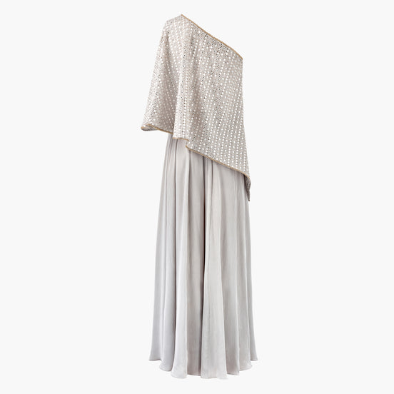 A one shoulder cape with thread and mirror detailing paired with a satin skirt, in grey. Customisable in colour.