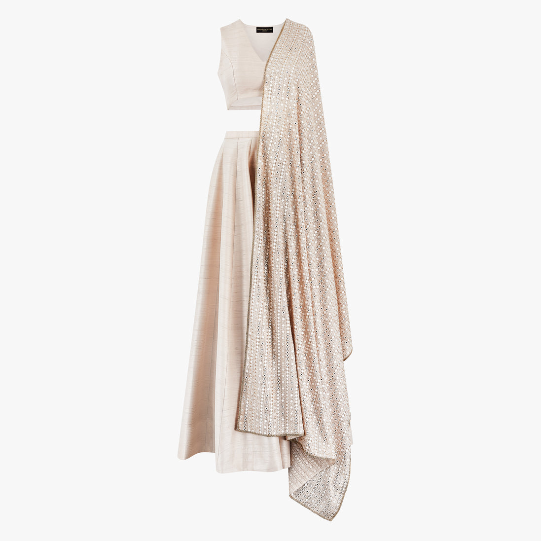 A cream semi raw silk lehenga with a crop top and a mirror dupatta. Designed by Shenena Sethi