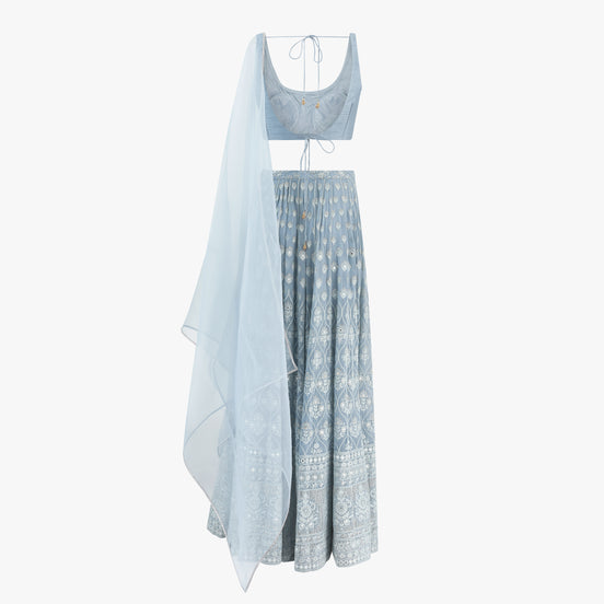A light blue chikan kari lehenga with a plain semi raw silk top and pure organza dupatta, designed by Shenena Sethi