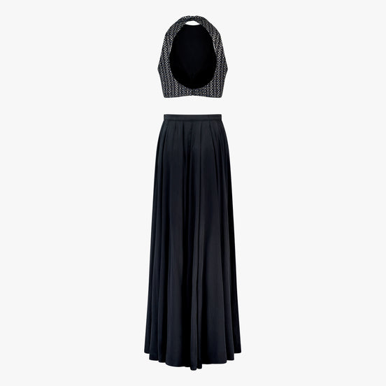 Lyla, a two-piece outfit with a mirror and thread work blouse and a georgette satin skirt in black, designed by Shenena Sethi
