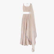 A nude pink chikan kari lehenga, semi raw silk top, accompanied by a soft pure organza dupatta with tassels on the ends, designed by Shenena Sethi